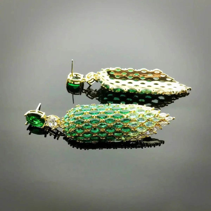 Gold-colored leaf earrings with green zirconia